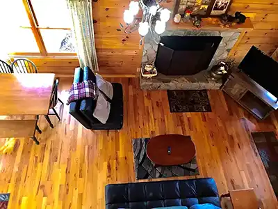 view from the the loft overlooking the living area and fireplace in the cabin